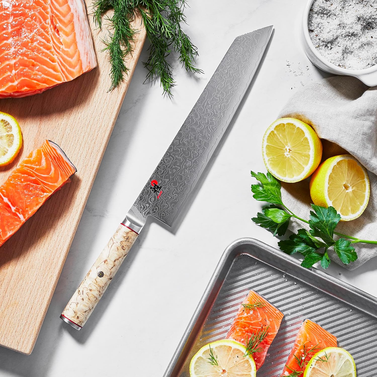 Miyabi Birchwood SG2 kiritsuke slicing salmon on a cutting board