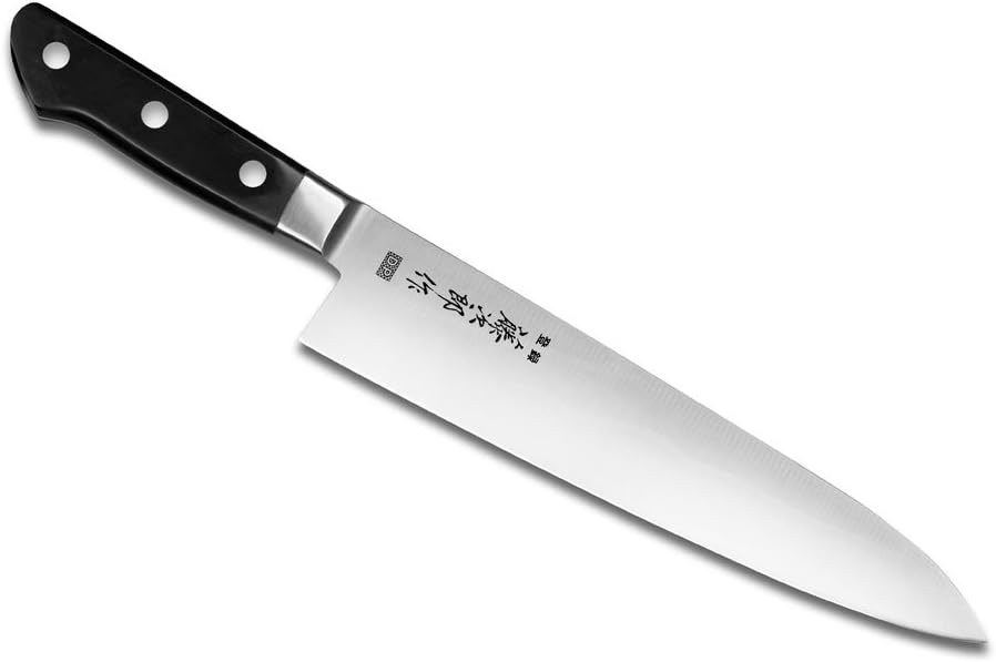 Long 24 cm Tojiro DP gyuto blade angled across a white background, showing the black three-rivet handle and polished stainless bolster