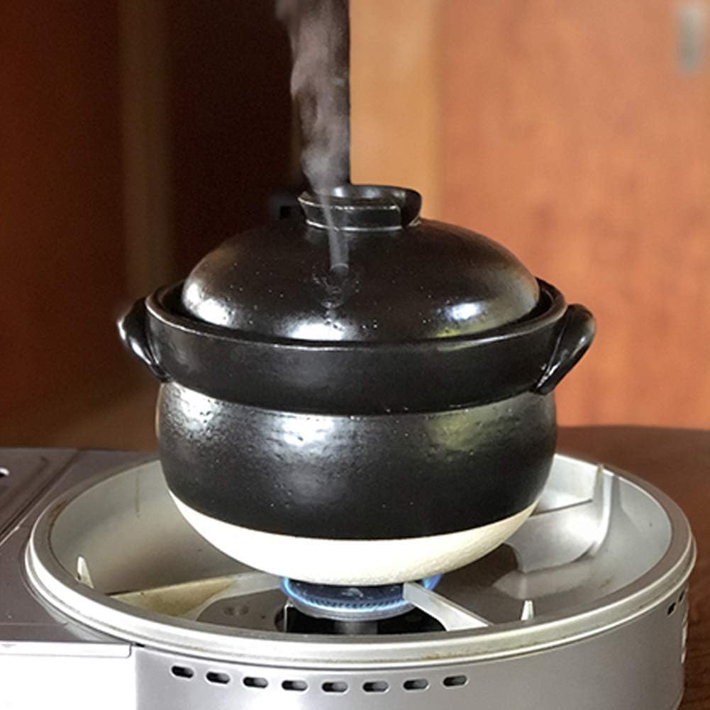 Banko donabe rice pot cooking on a gas stove with steam rising from the lid
