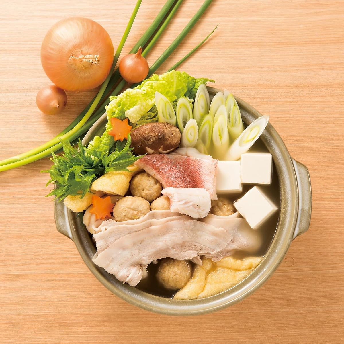 Pork, fish, tofu plus vegetables simmering in a Ginpo donabe hot pot