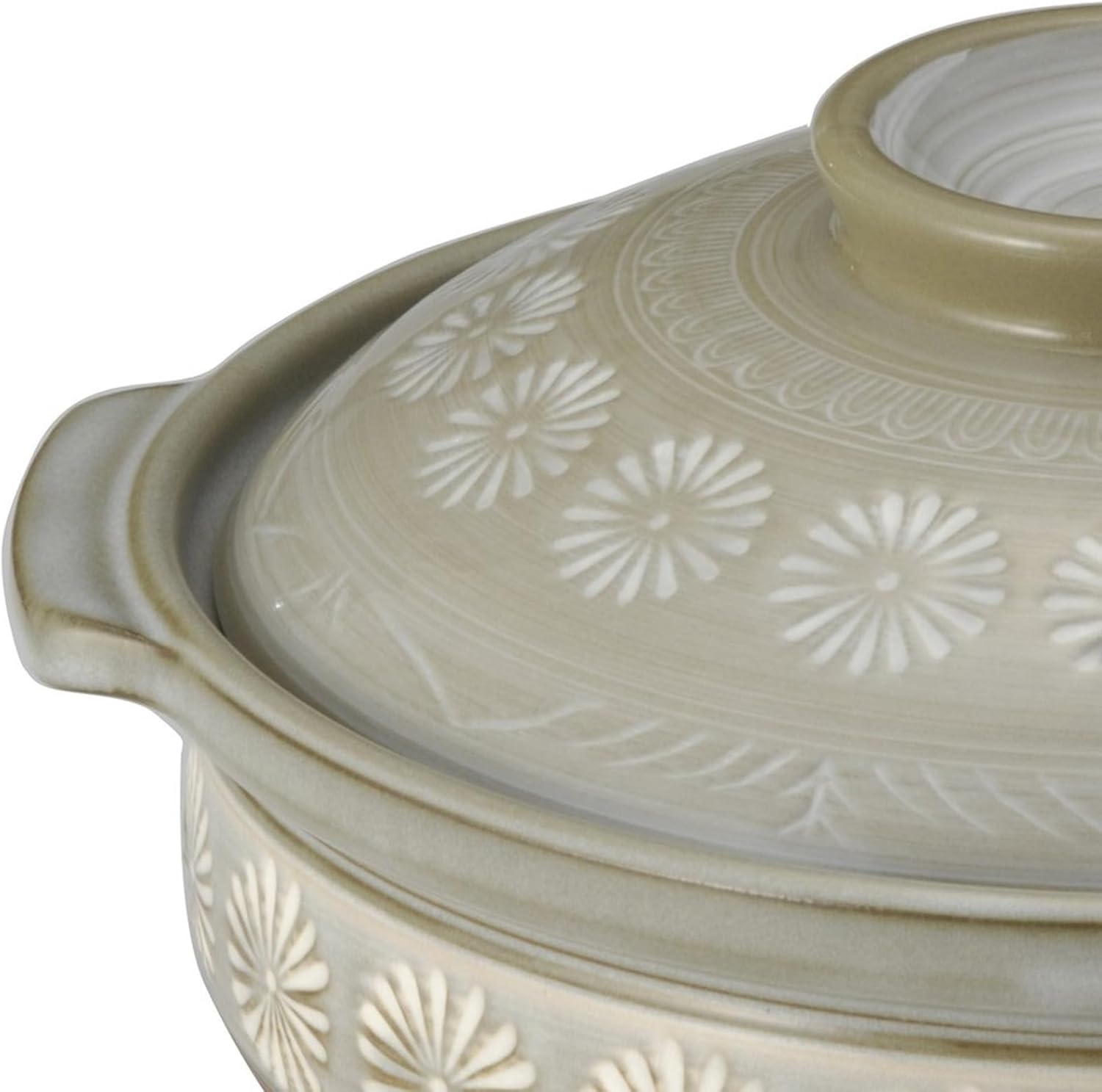 Close-up of the white slip-filled chrysanthemum stamps on the Ginpo donabe lid