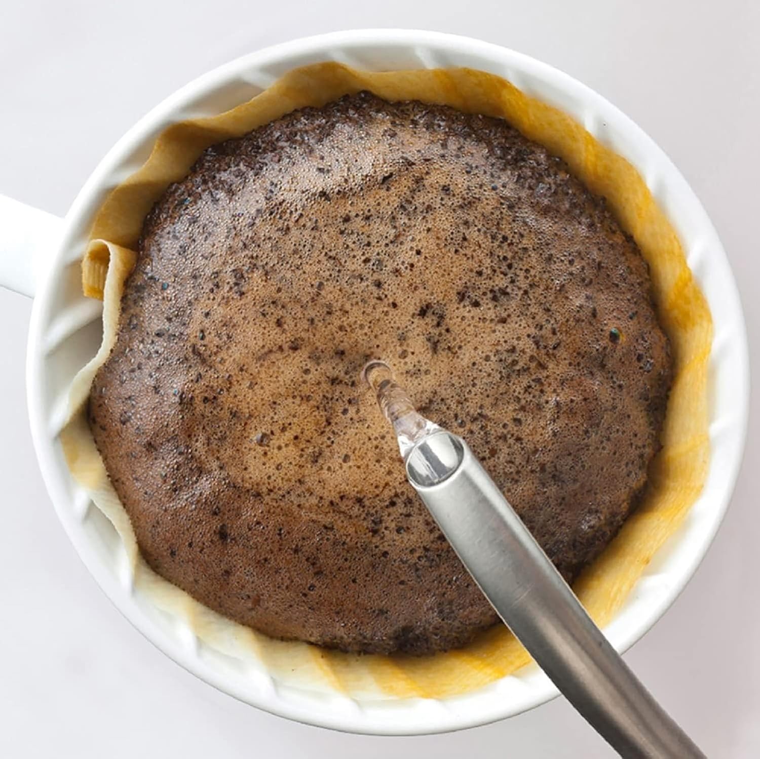 Top-down view of coffee blooming inside a Hario V60 cone filter