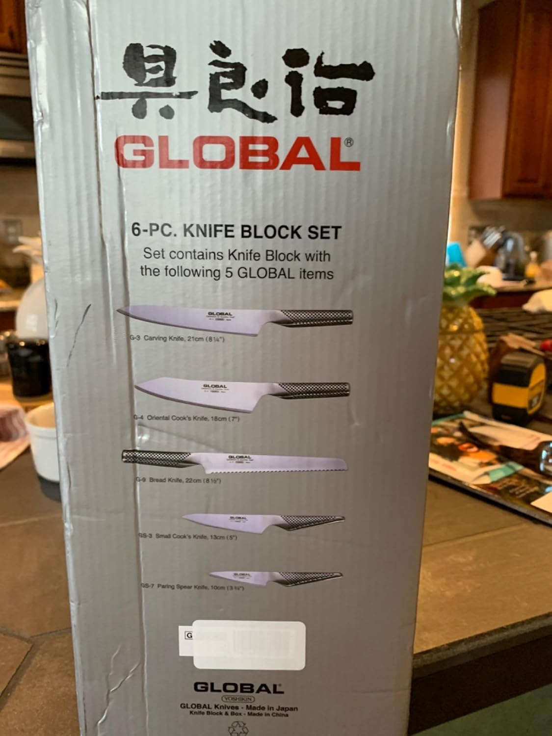Global 6-piece knife block set box on a home kitchen counter listing the contents