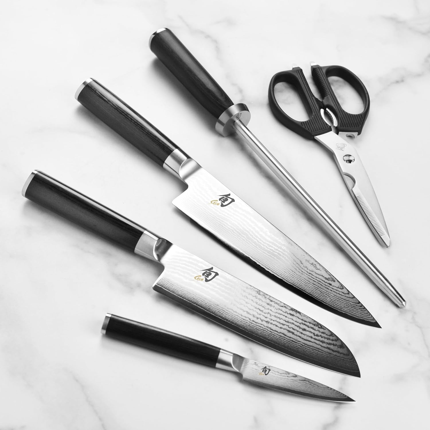 Shun Classic knives showing 68-layer Damascus pattern with shears and honing steel
