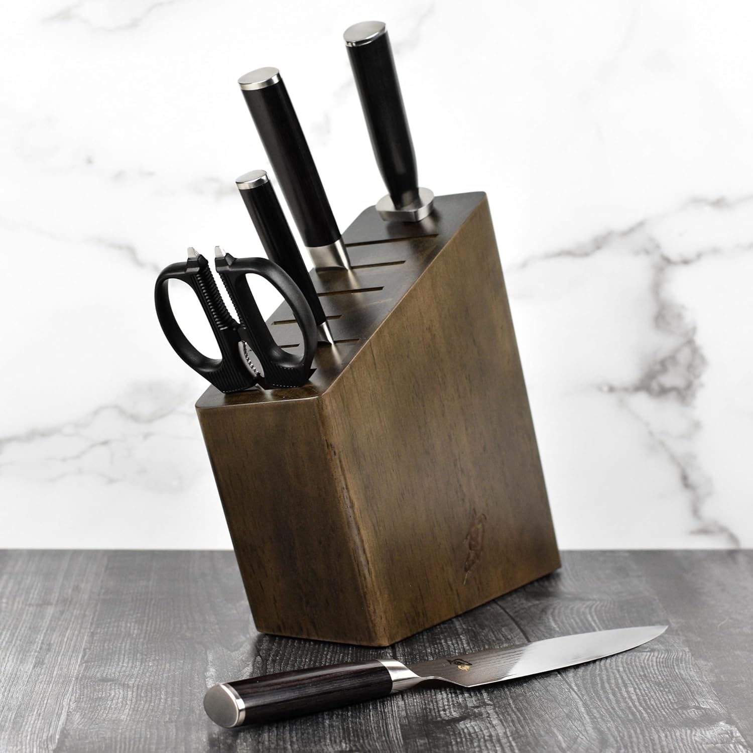 Shun Classic knife block on a marble kitchen counter with chef knife laid in front