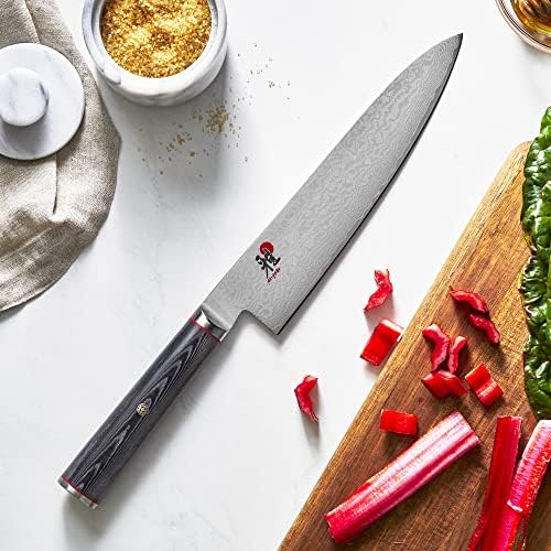 Miyabi Kaizen chef's knife slicing red vegetables on a kitchen counter