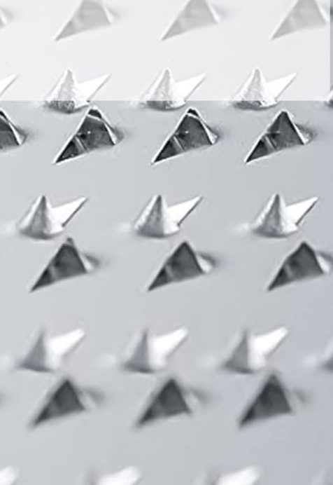 Close-up of the raised triangular steel teeth on the TIKUSAN grating surface