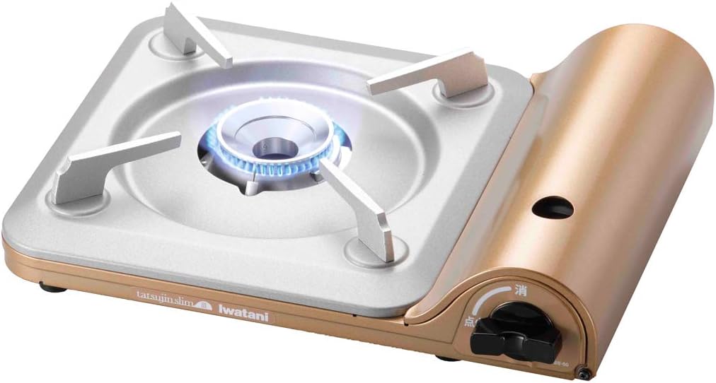 Iwatani Tatsujin Slim III cassette stove in gold with a lit blue flame on its stainless top plate