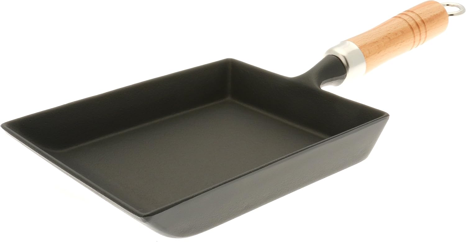 Iwachu black Nambu cast iron tamagoyaki pan with a turned wooden handle and hanging ring