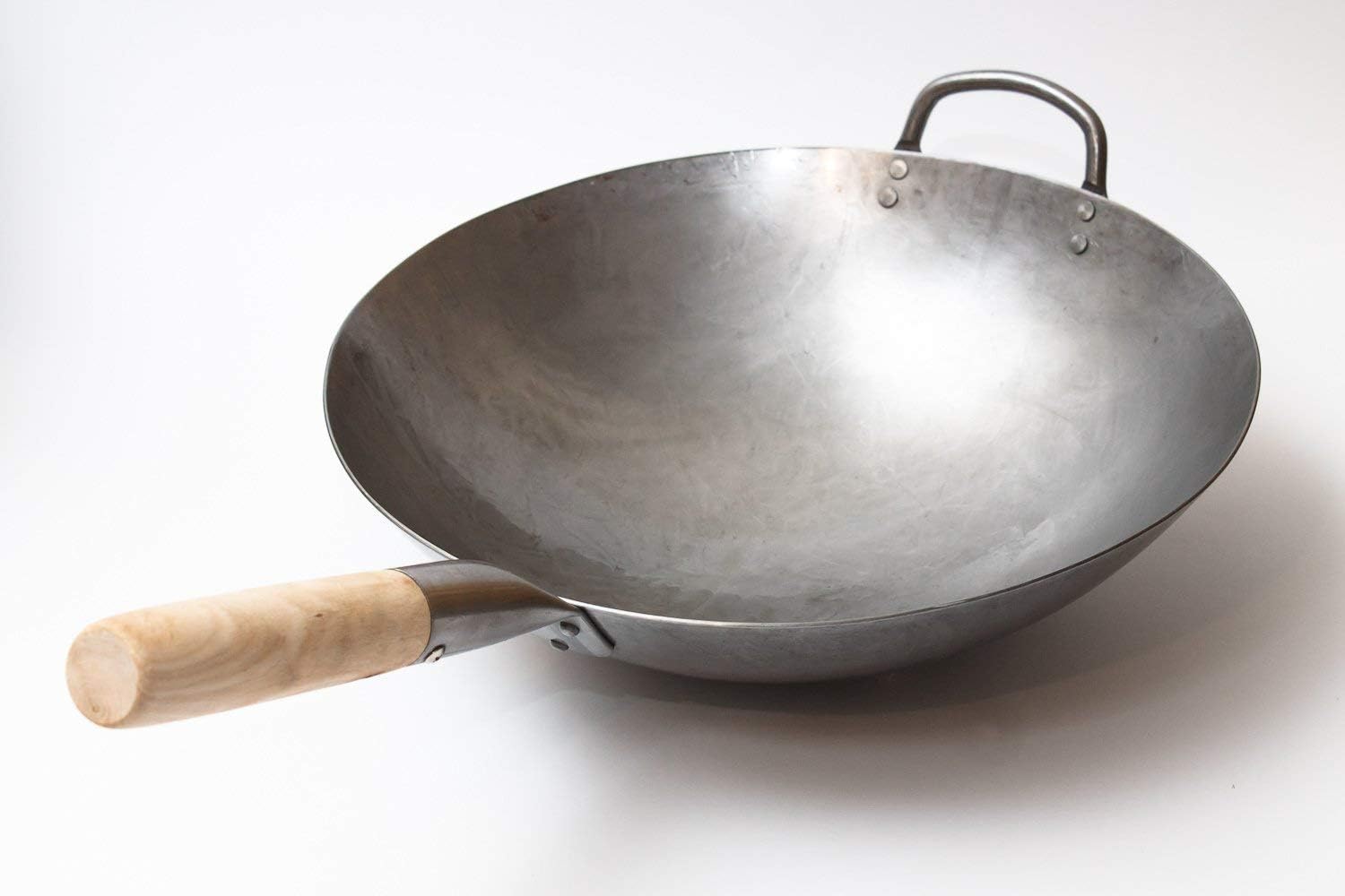Side view of the Craft Wok showing the deep round bowl and the loop helper handle