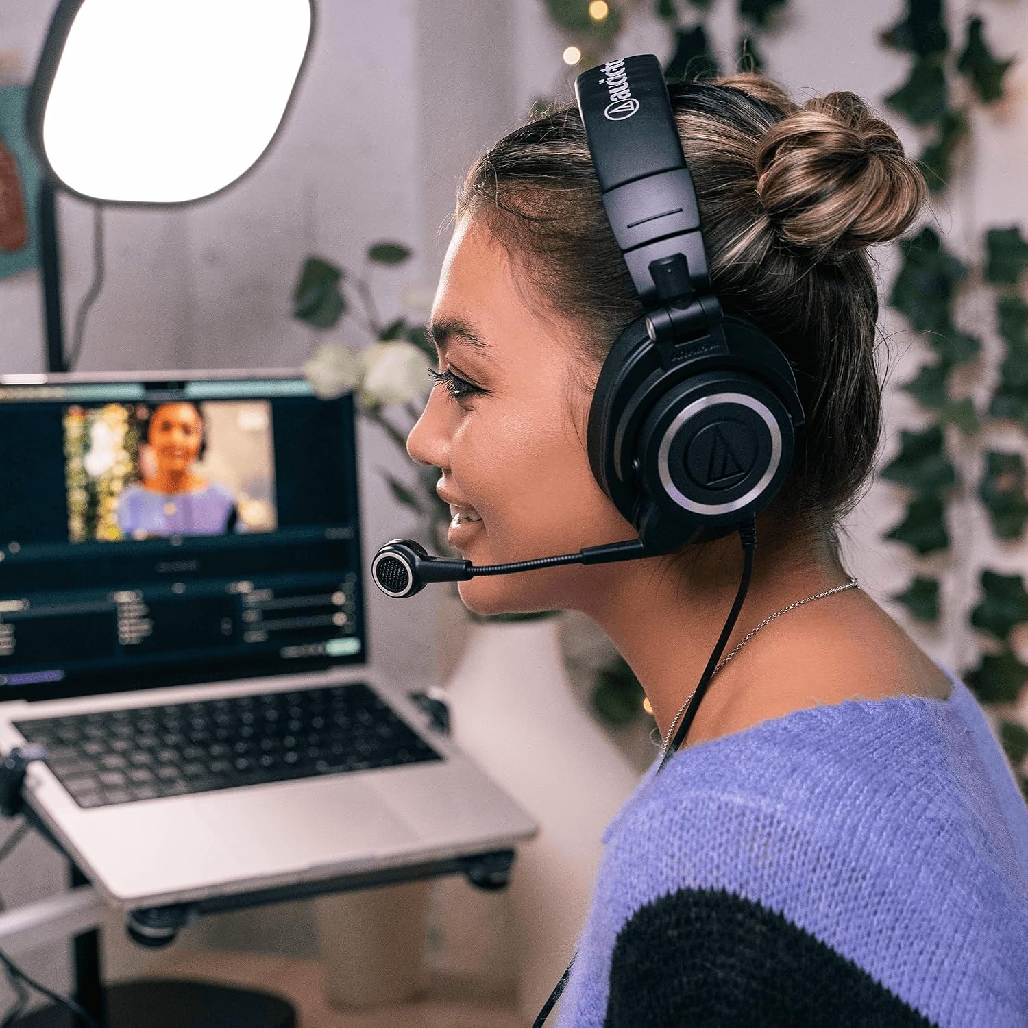 Streamer wearing the Audio-Technica ATH-M50xSTS headset at a laptop with a ring light