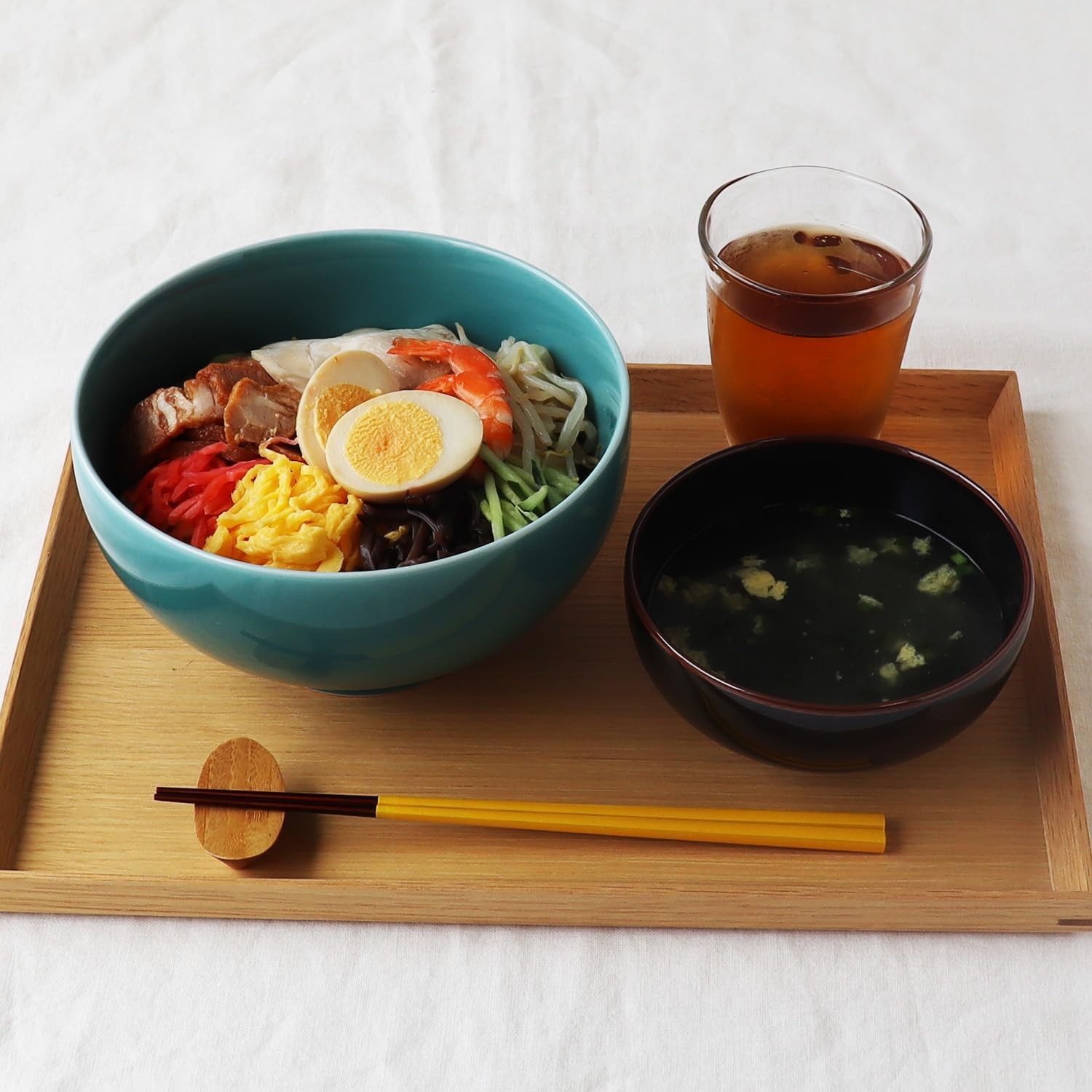 Hakusan celadon bowl of cold noodles with egg plus vegetables on a wooden tray