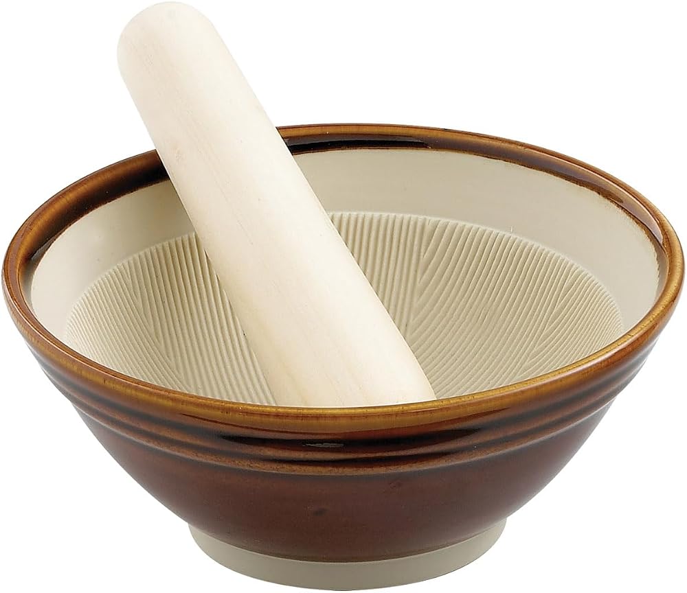 Helen's Asian Kitchen brown-glazed ceramic suribachi with a cream ridged interior and a short wooden pestle