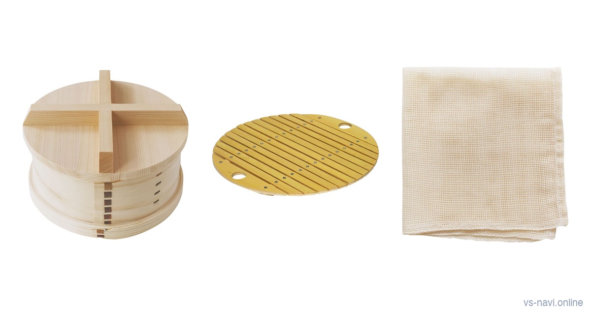 A Japanese wooden seiro steamer with a plank lid, a round bamboo steaming rack and a folded cotton steamer cloth on a white background
