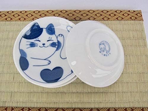 Cat plate next to a plate turned over to show the stamped back
