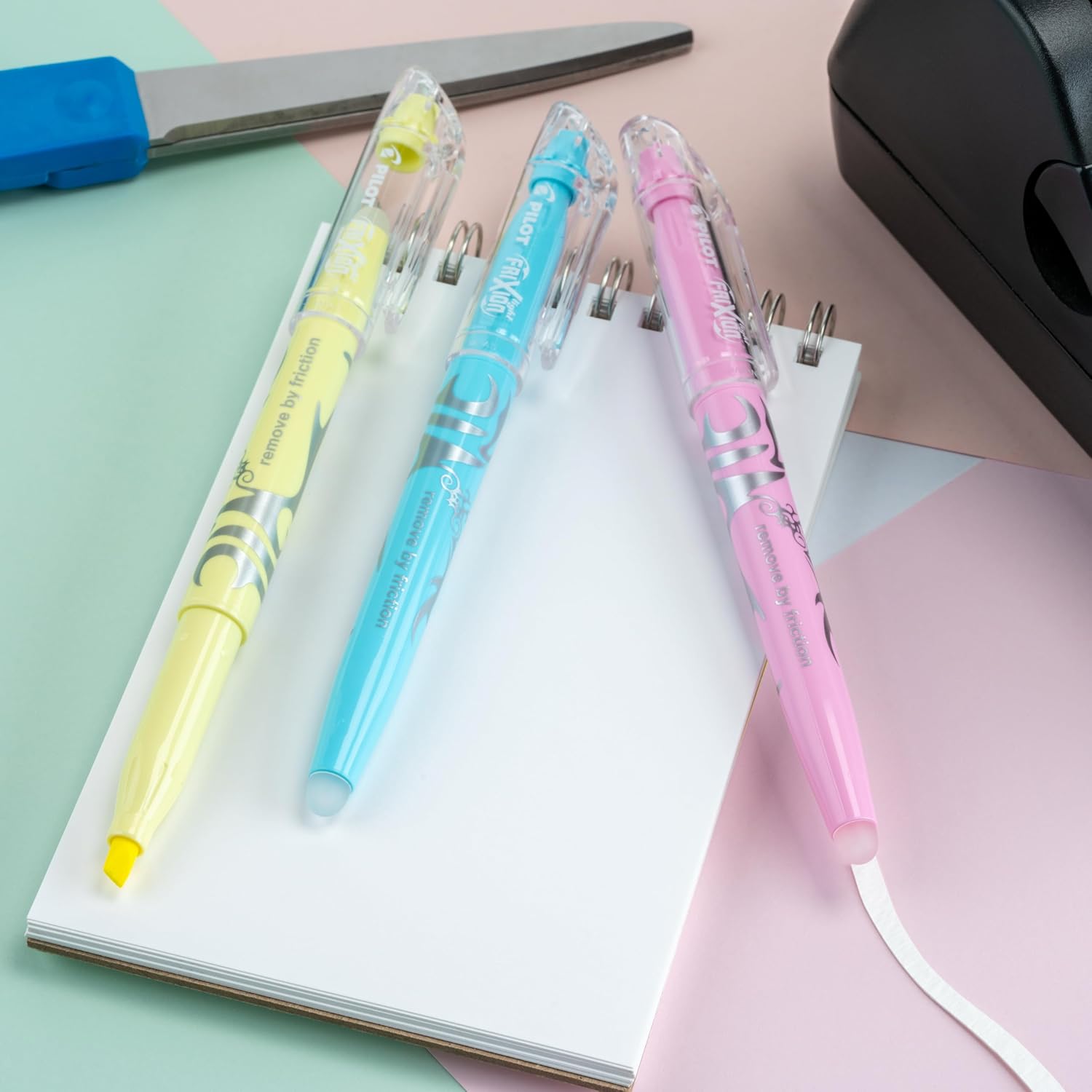 Pilot FriXion Light highlighters on a spiral notepad on a desk