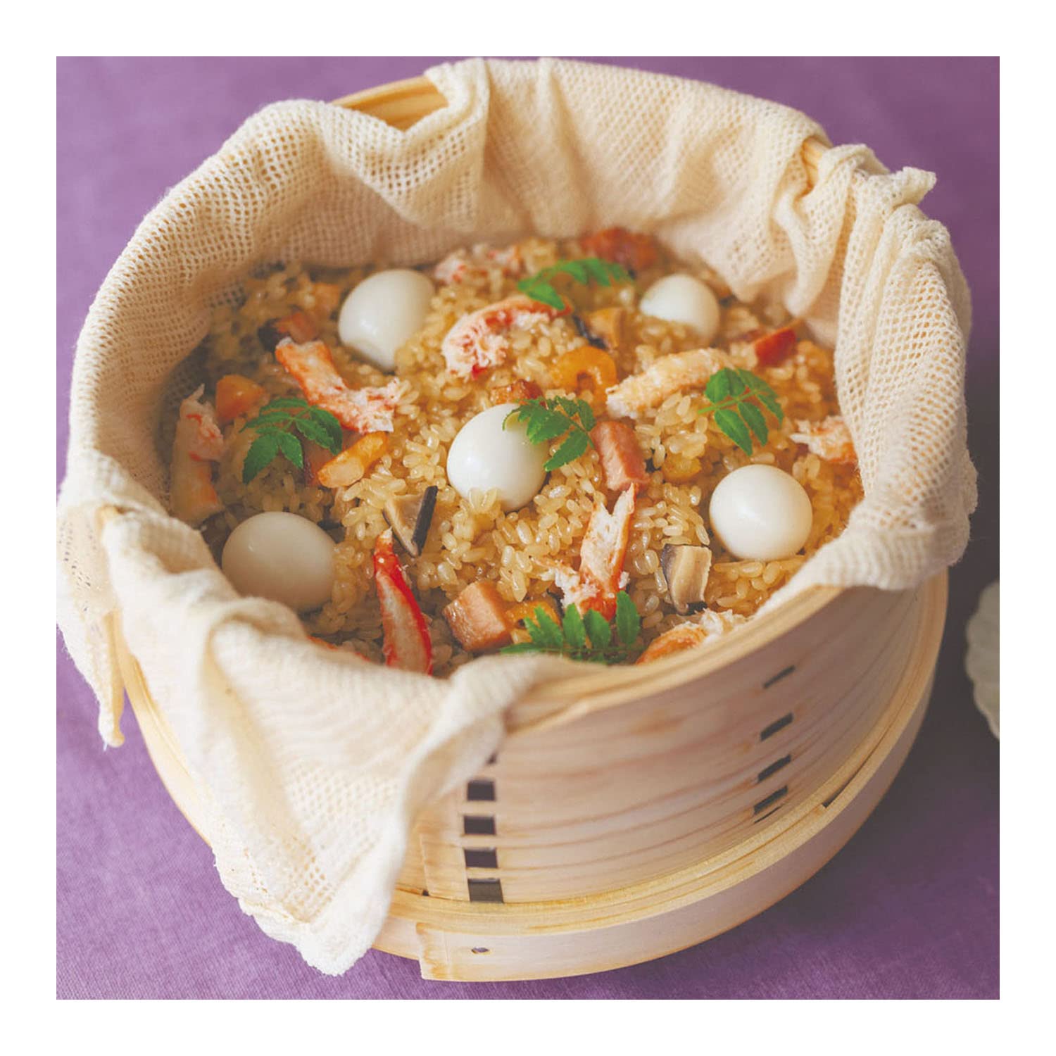 Seiro lined with a cotton steamer cloth and filled with steamed seafood rice and quail eggs