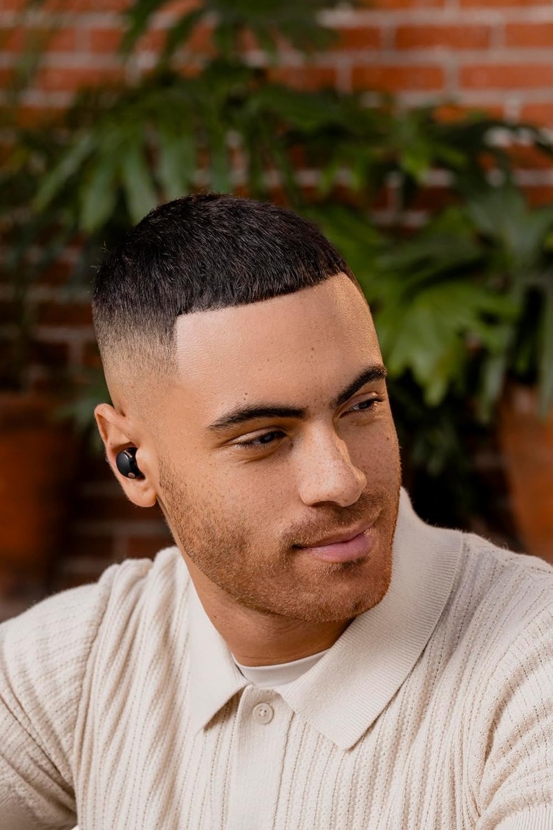 Man wearing Sony WF-1000XM5 earbuds