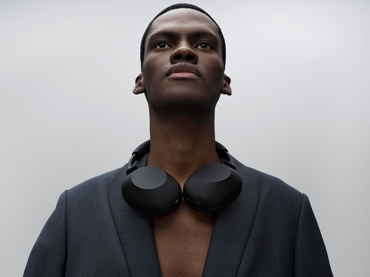 Person wearing Sony WH-1000XM6 around the neck