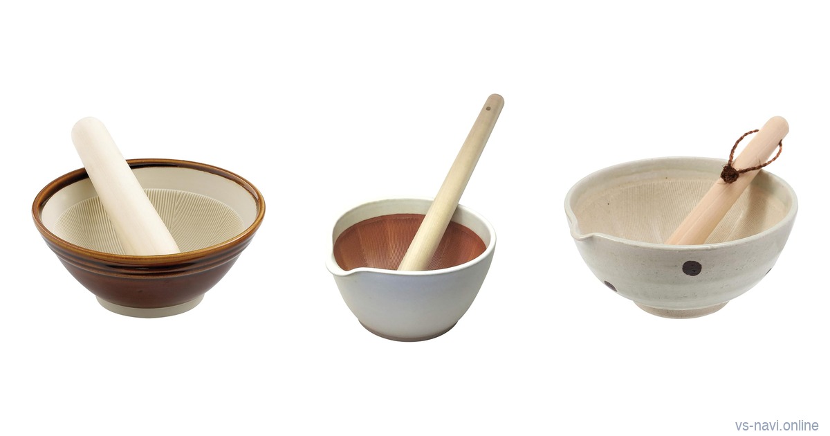 Three Japanese suribachi mortars with wooden pestles on a white background: a brown-glazed classic bowl, a white Iwami ware bowl with a red-brown interior and a white polka-dot Mino ware bowl with a spout