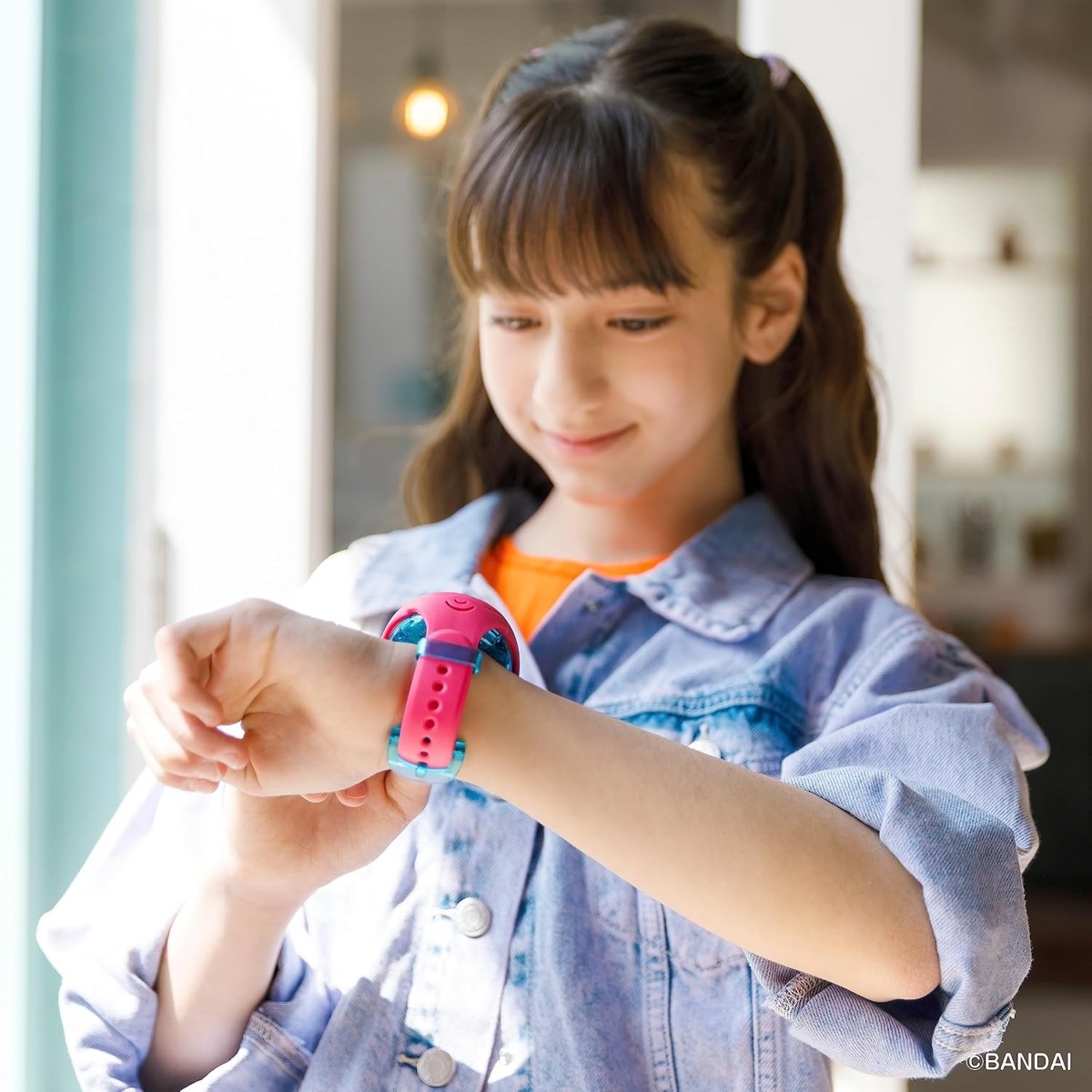 Child wearing Tamagotchi Uni on the wrist