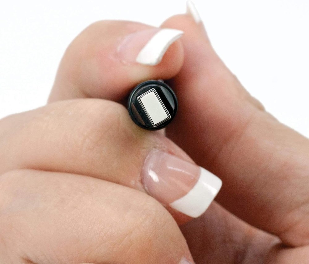 Close-up of the flat rectangular tip of the Tombow MONO Zero eraser held between two fingers