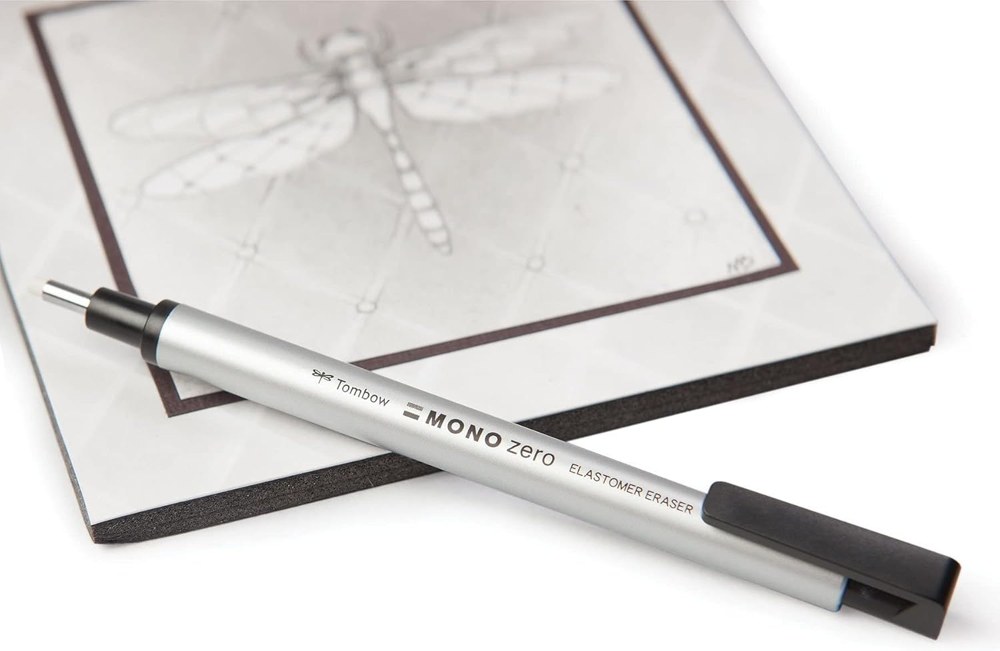 Tombow MONO Zero round eraser resting on a pencil drawing of a dragonfly