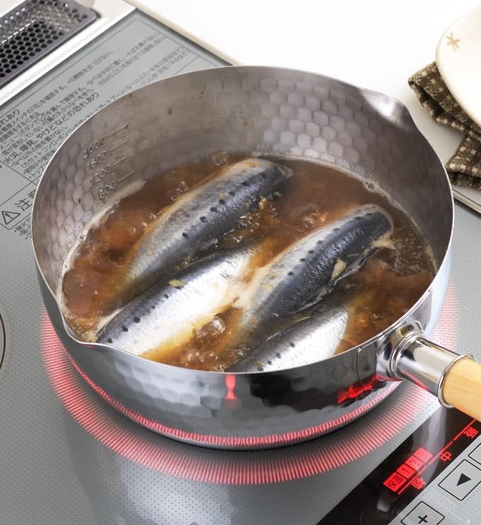 Yoshikawa yukihira pan simmering fish in soy broth on an induction cooktop